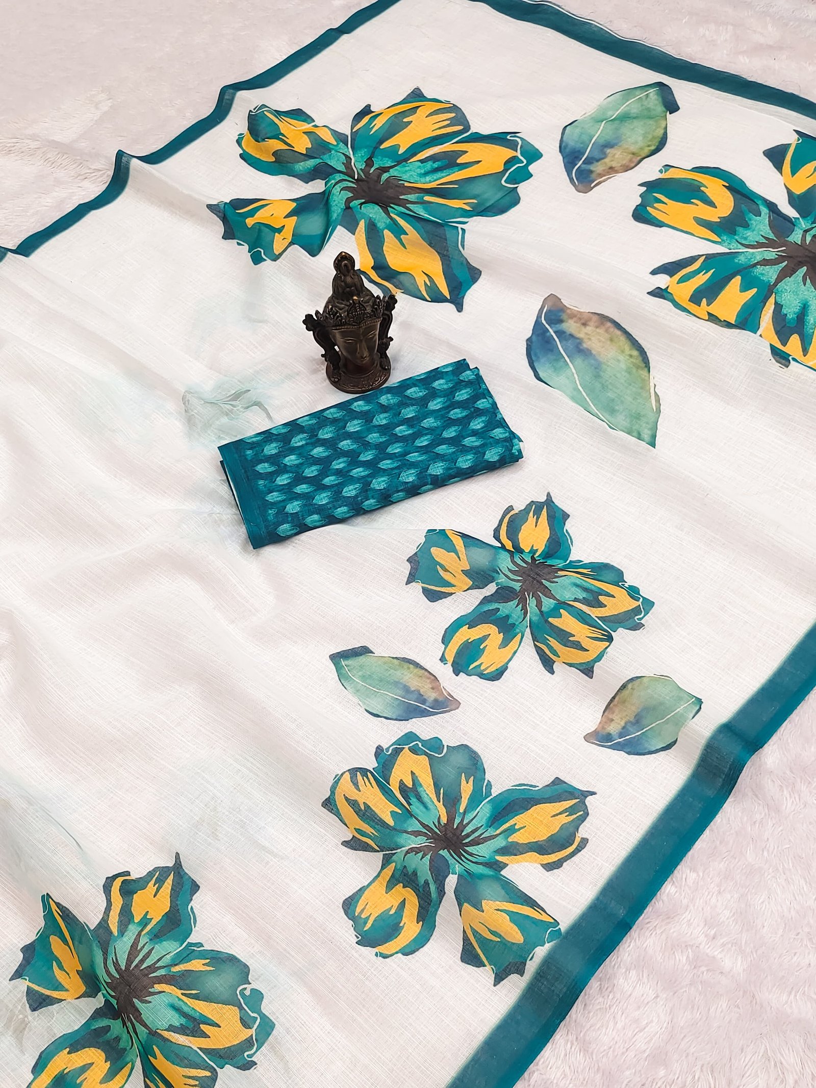 Elegant white organza saree featuring large turquoise-yellow